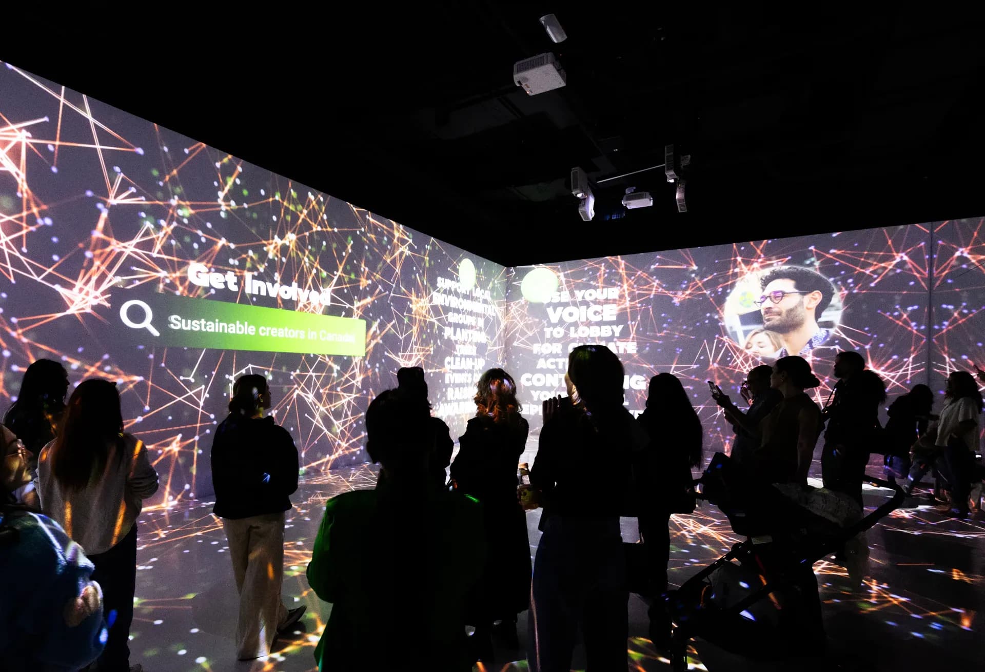 People in a projection room, dark and lit up on the walls